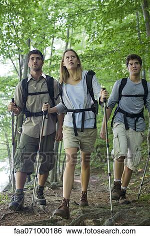 Friends hiking in woods View Large Photo Image Stock Photograph - Friends hiking in woods. Fotosearch