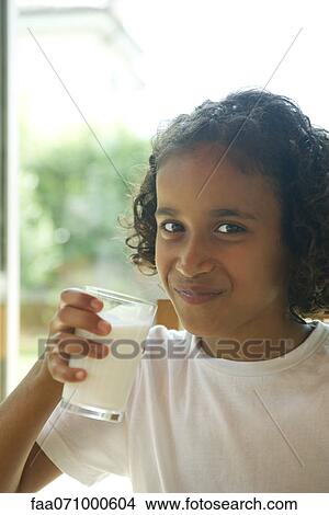 Girl drinking glass of milk, portrait View Large Photo Image Picture - Girl drinking glass of milk, portrait. Fotosearch