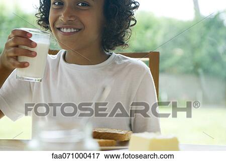 Girl drinking glass of milk View Large Photo Image Stock Photo - Girl drinking glass of milk. Fotosearch