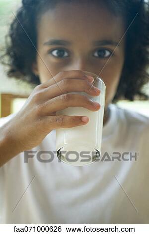 Stock Photograph - Girl drinking glass of milk. Fotosearch