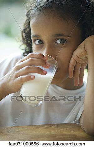 Girl drinking milk View Large Photo Image Stock Photograph - Girl drinking milk. Fotosearch