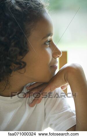 Picture - Girl looking away in thought, portrait. Fotosearch
