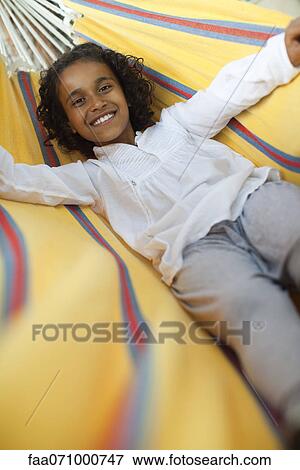 Girl lying in hammock, portrait View Large Photo Image Stock Photo - Girl lying in hammock, portrait. Fotosearch