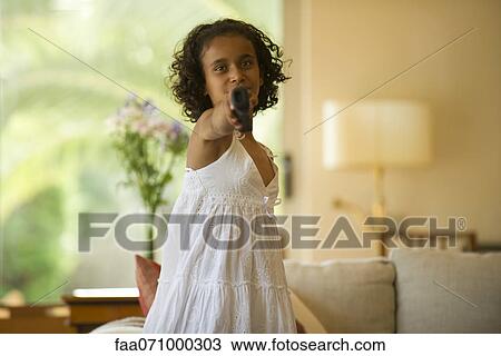 Girl playing video game using wireless controller View Large Photo Image Stock Image - Girl playing video game using wireless controller. Fotosearch