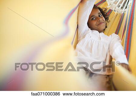 Girl relaxing in hammock, portrait View Large Photo Image Stock Photograph - Girl relaxing in hammock, portrait. Fotosearch