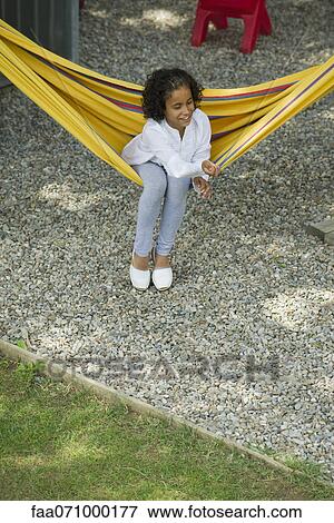 Girl sitting on hammock View Large Photo Image Stock Photo - Girl sitting on hammock. Fotosearch