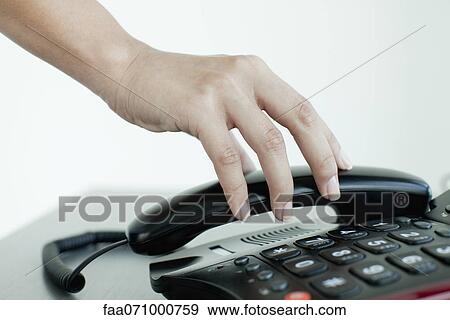 Hand picking up telephone receiver, cropped View Large Photo Image Stock Photo - Hand picking up telephone receiver, cropped. Fotosearch