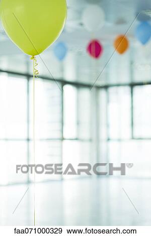 Helium balloons in new office View Large Photo Image Stock Photo - Helium balloons in new office. Fotosearch
