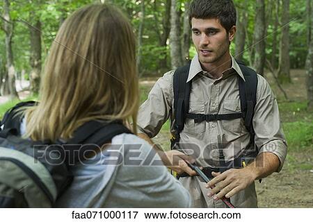 Hikers chatting in woods View Large Photo Image Stock Photo - Hikers chatting in woods. Fotosearch