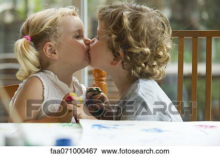 Stock Photo - Little boy and girl kissing. Fotosearch