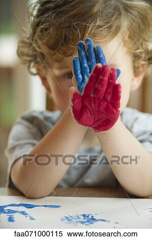 Little boy holding paint covered hands in front of his face View Large Photo Image Stock Photography - Little boy holding paint covered hands in front of his face. Fotosearch