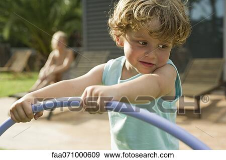 Little boy playing with plastic hoop View Large Photo Image Stock Photo - Little boy playing with plastic hoop. Fotosearch