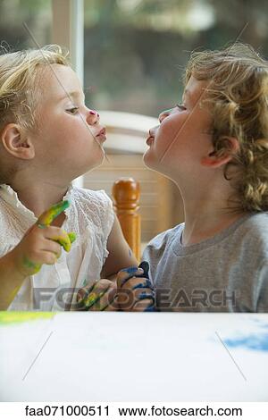 Little girl and boy looking at each other and puckering lips View Large Photo Image Stock Image - Little girl and boy looking at each other and puckering lips. Fotosearch