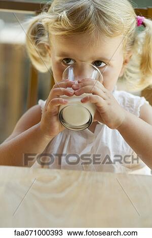 Little girl drinking glass of milk View Large Photo Image Stock Image - Little girl drinking glass of milk. Fotosearch