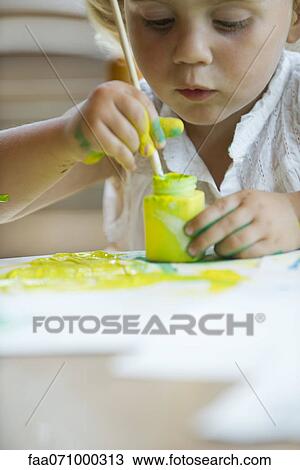 Stock Image - Little girl painting. Fotosearch