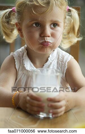Little girl with milk mustache enjoying glass of milk View Large Photo Image Stock Photograph - Little girl with milk mustache enjoying glass of milk. Fotosearch