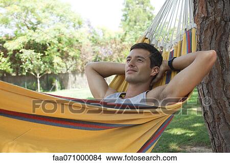 Man relaxing in hammock View Large Photo Image Picture - Man relaxing in hammock. Fotosearch