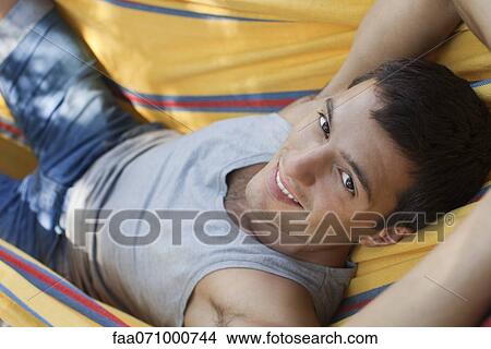 Man relaxing in hammock, portrait View Large Photo Image Picture - Man relaxing in hammock, portrait. Fotosearch