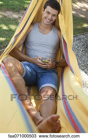 Man relaxing in hammock, portrait View Large Photo Image Stock Image - Man relaxing in hammock, portrait. Fotosearch