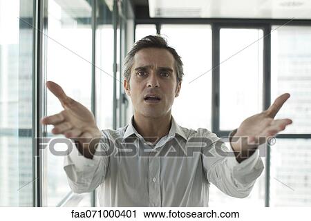 Stock Image - Man throwing up hands in frustration. Fotosearch