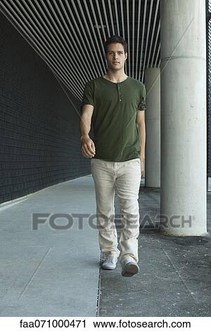 Man walking in outdoor corridor View Large Photo Image Stock Image - Man walking in outdoor corridor. Fotosearch