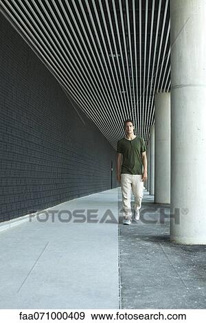 Man walking on colonnade View Large Photo Image Stock Photo - Man walking on colonnade. Fotosearch