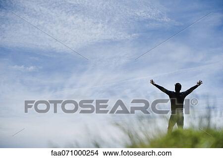 Man with arms up in nature, rear view View Large Photo Image Picture - Man with arms up in nature, rear view. Fotosearch