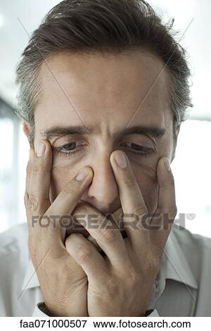 Stock Photo - Man with hands covering face. Fotosearch