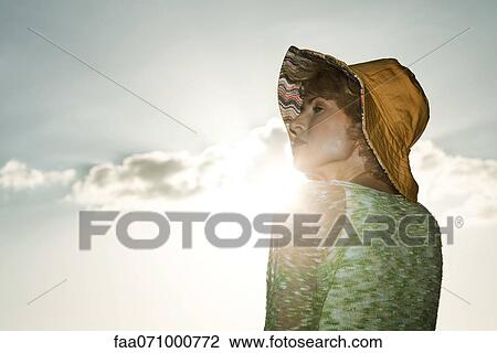 Stock Image - Mid-adult woman outdoors, portrait. Fotosearch