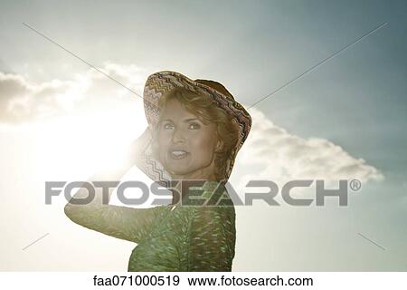 Mid-adult woman outdoors, portrait View Large Photo Image Stock Photo - Mid-adult woman outdoors, portrait. Fotosearch