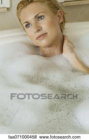 Mid-adult woman unwinding in bubble bath, portrait View Large Photo Image Stock Photo - Mid-adult woman unwinding in bubble bath, portrait. Fotosearch
