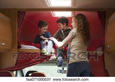 Mother and young boys in motor home View Large Photo Image Stock Photo - Mother and young boys in motor home. Fotosearch