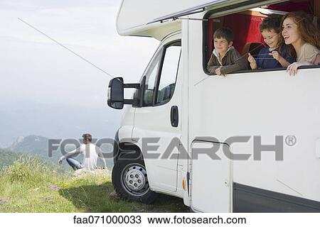 Mother and young boys looking out motor home window View Large Photo Image Stock Image - Mother and young boys looking out motor home window. Fotosearch