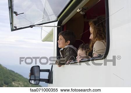 Mother and young boys looking out motor home window View Large Photo Image Stock Photography - Mother and young boys looking out motor home window. Fotosearch