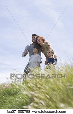 Parents and young boys looking at view View Large Photo Image Stock Photo - Parents and young boys looking at view. Fotosearch