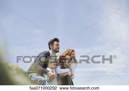 Parents and young boys standing in nature View Large Photo Image Stock Image - Parents and young boys standing in nature. Fotosearch