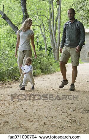 Parents hiking in woods with toddler View Large Photo Image Picture - Parents hiking in woods with toddler. Fotosearch