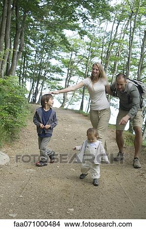 Parents playing with children in woods View Large Photo Image Picture - Parents playing with children in woods. Fotosearch