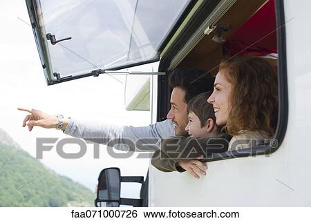 Stock Photograph - Parents with young son in motor home, father pointing into distance. Fotosearch