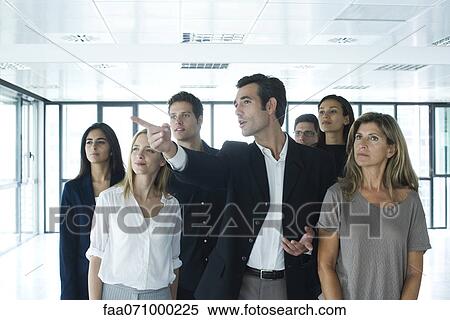 Real estate agent giving tour to business people in new office View Large Photo Image Stock Photography - Real estate agent giving tour to business people in new office. Fotosearch