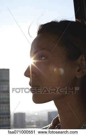 Silhouette of woman's face, sunshine in background View Large Photo Image Stock Image - Silhouette of woman's face, sunshine in background. Fotosearch
