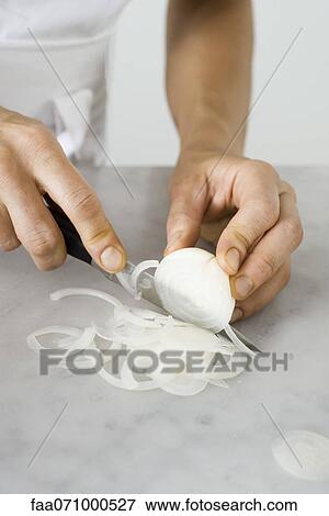 Stock Photo - Slicing an onion. Fotosearch