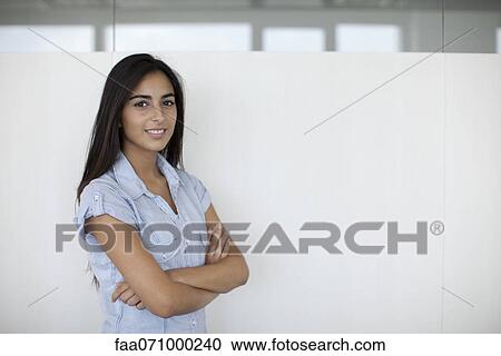 Smiling woman in office with arms folded, portrait View Large Photo Image Stock Image - Smiling woman in office with arms folded, portrait. Fotosearch