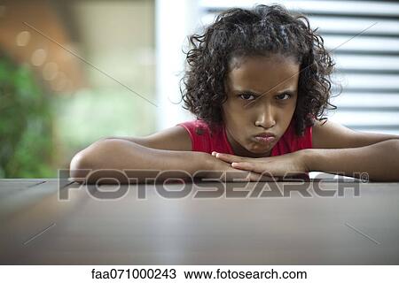 Sulky girl scowling at camera View Large Photo Image Stock Image - Sulky girl scowling at camera. Fotosearch