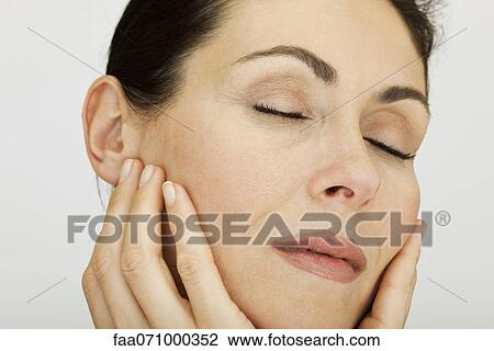 Woman feeling softness of complexion View Large Photo Image Stock Image - Woman feeling softness of complexion. Fotosearch