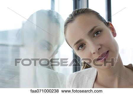Woman leaning against window, head tilted View Large Photo Image Stock Photo - Woman leaning against window, head tilted. Fotosearch