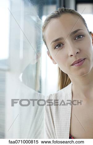 Woman leaning against window View Large Photo Image Stock Photography - Woman leaning against window. Fotosearch