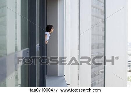 Woman leaning out of window looking at view View Large Photo Image Stock Photo - Woman leaning out of window looking at view. Fotosearch