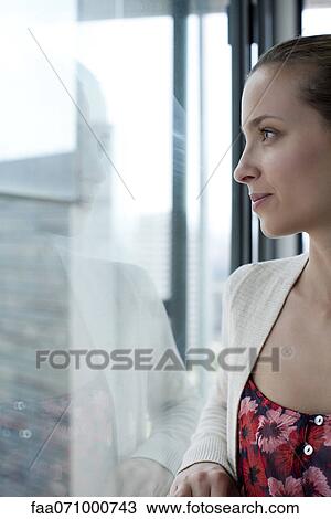 Woman looking out of window, cropped View Large Photo Image Stock Image - Woman looking out of window, cropped. Fotosearch
