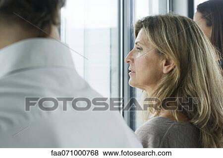 Stock Photo - Woman looking out window. Fotosearch